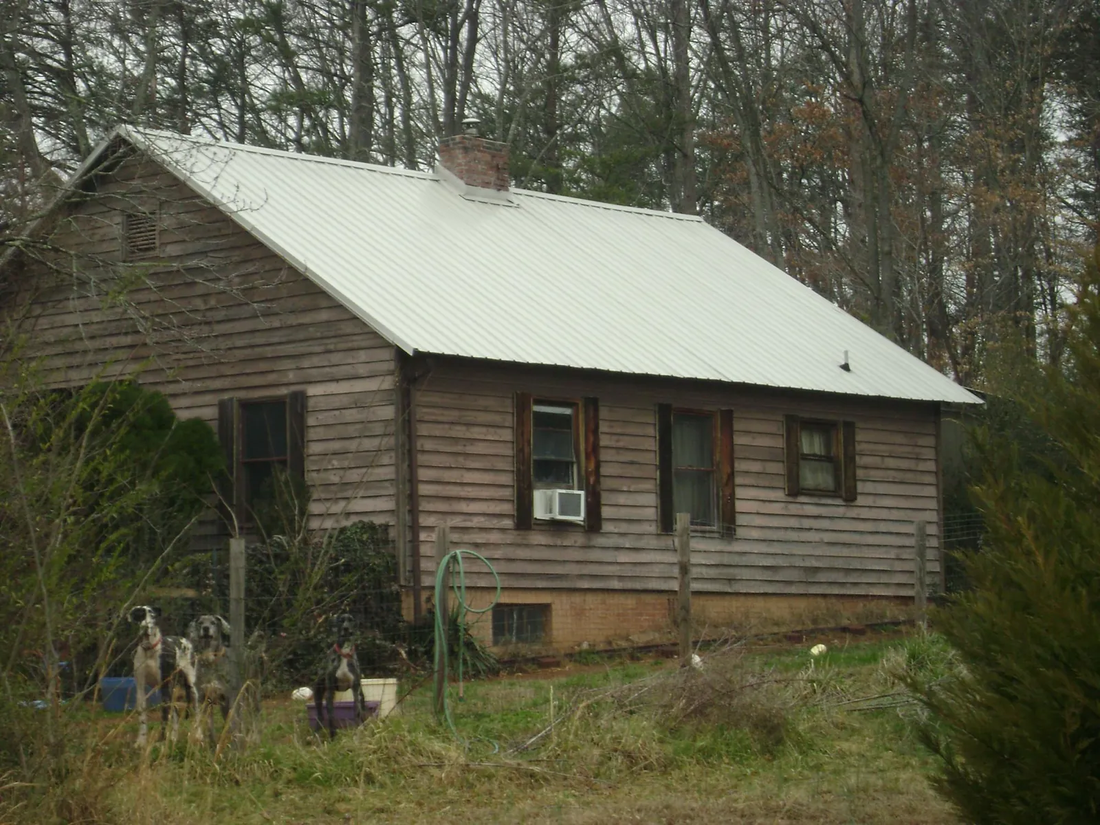 White metal roof on an old wood sided farmhouse, from a Metal Roof Installation job in Chillicothe